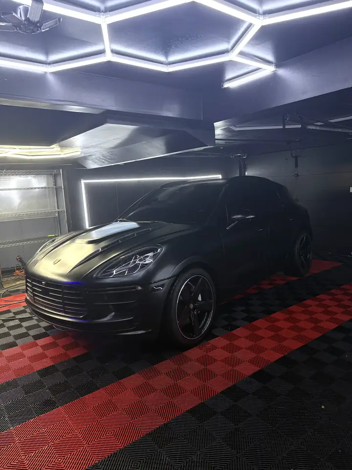 Black Porsche Macan in satin black film in the studio